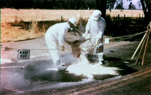 Two men cleaning up a spill