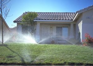 front yard of home being irrigated with sprinkler system