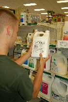 man reading a pesticide label